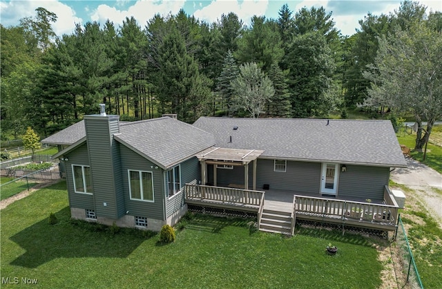 back of house with a wooden deck and a yard