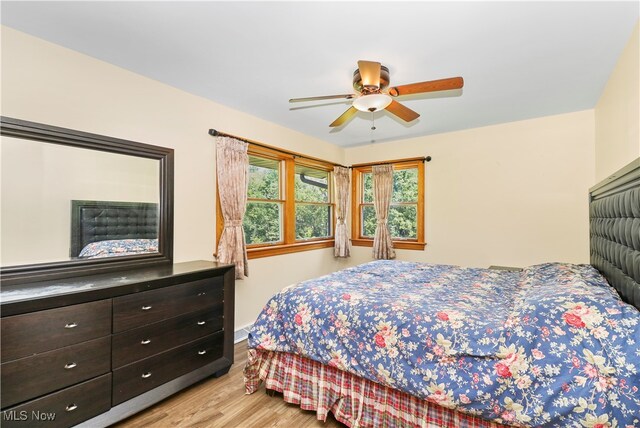 bedroom with light hardwood / wood-style flooring and ceiling fan