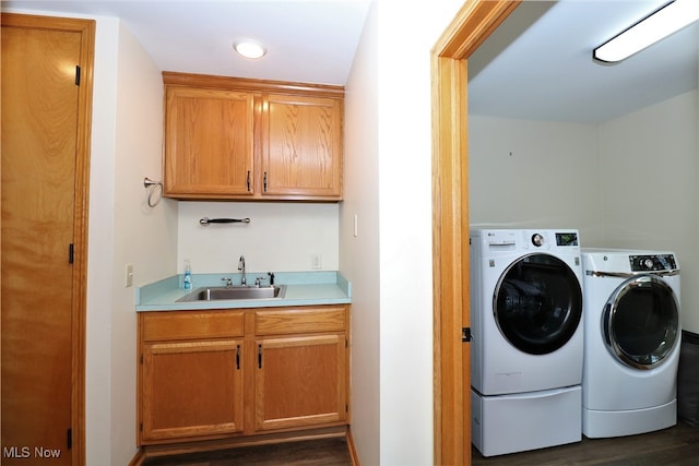 washroom with independent washer and dryer, cabinets, sink, and dark hardwood / wood-style floors