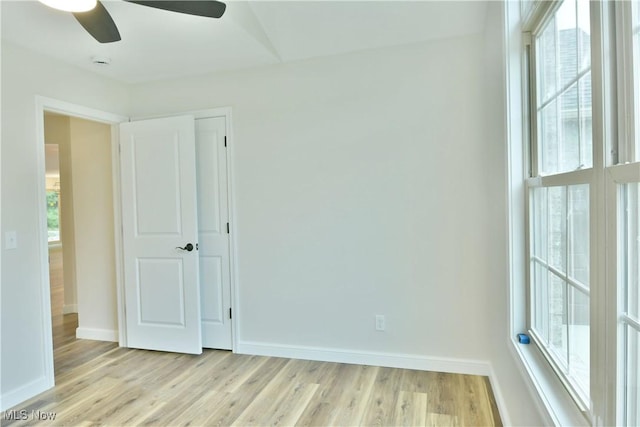 empty room with light wood-type flooring and ceiling fan