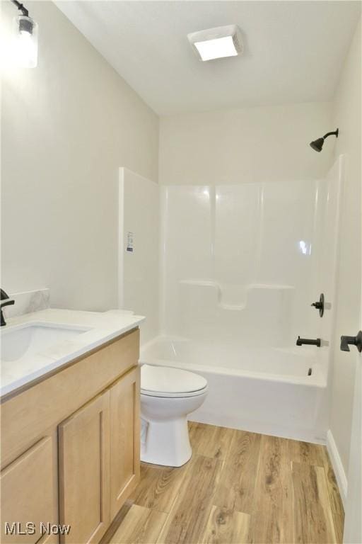 full bathroom featuring vanity, toilet, hardwood / wood-style floors, and bathing tub / shower combination