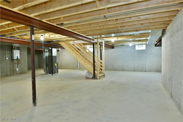 basement featuring tankless water heater and heating unit