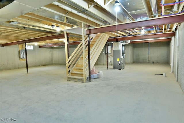 basement with electric panel and heating unit