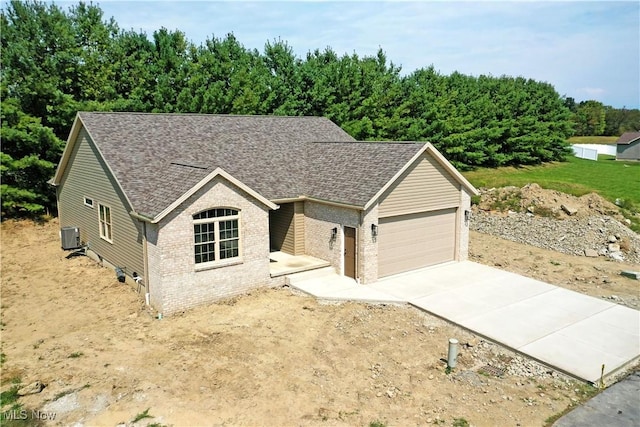 view of front of house with cooling unit and a garage