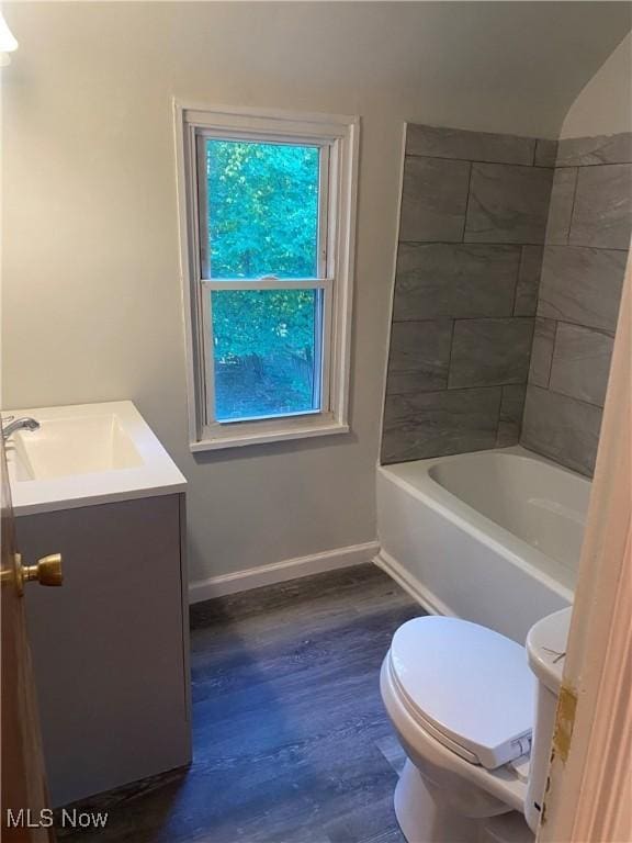 full bathroom with wood-type flooring, vanity, toilet, and tiled shower / bath