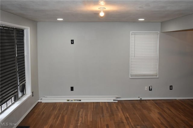 unfurnished room with dark hardwood / wood-style floors