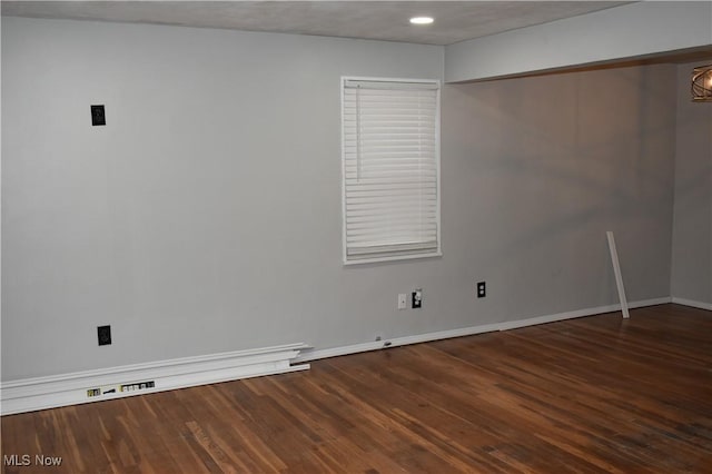 spare room with wood-type flooring and a textured ceiling