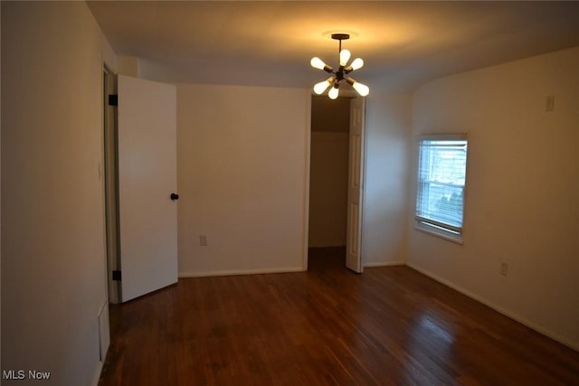 interior space featuring dark hardwood / wood-style floors, a chandelier, and a closet