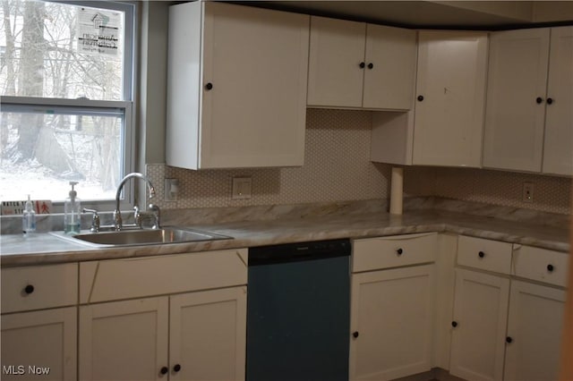 kitchen featuring decorative backsplash, sink, white cabinets, and black dishwasher