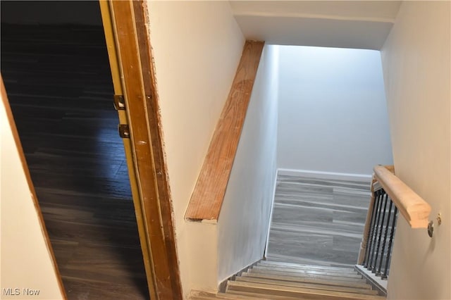 stairs featuring hardwood / wood-style flooring