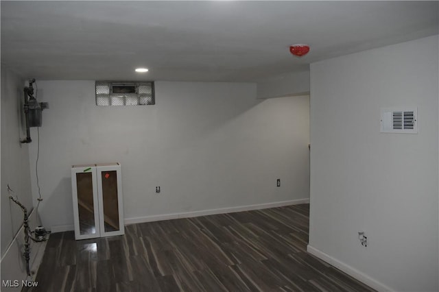 basement featuring dark hardwood / wood-style flooring