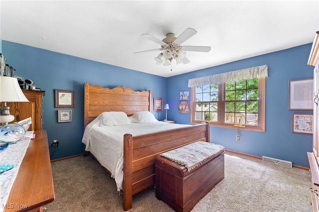 bedroom with dark colored carpet and ceiling fan