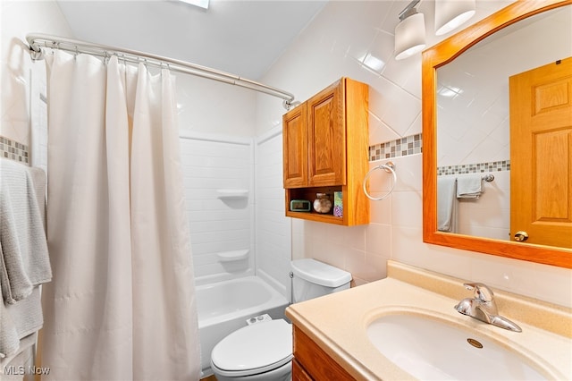 full bathroom featuring shower / bath combo, tasteful backsplash, vanity, tile walls, and toilet