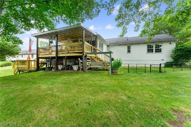 back of property featuring a lawn and a deck