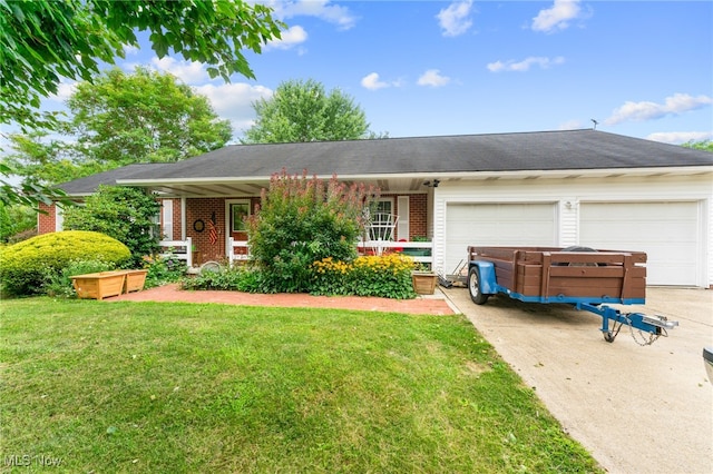 ranch-style home with a garage and a front lawn