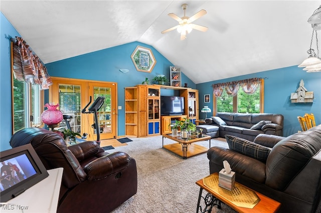 carpeted living room with ceiling fan and lofted ceiling