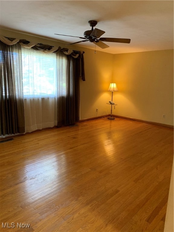 spare room featuring ceiling fan and hardwood / wood-style flooring