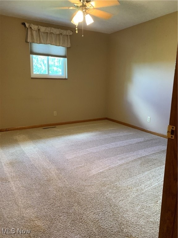 carpeted empty room with ceiling fan