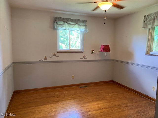 unfurnished room featuring light wood-type flooring and ceiling fan