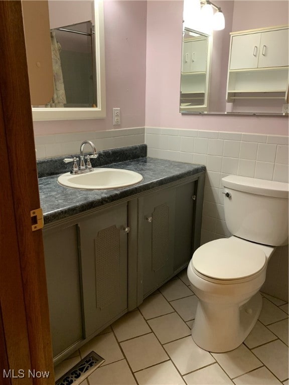 bathroom featuring tile walls, tile patterned floors, vanity, toilet, and a shower with curtain