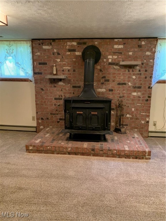 room details with a textured ceiling, carpet, baseboard heating, and a wood stove