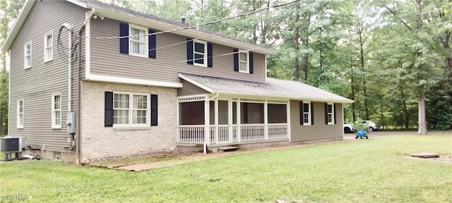 view of front of home featuring a front lawn and central air condition unit