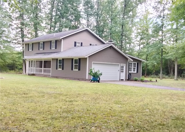 view of front of home featuring a front lawn and a garage