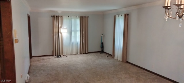 carpeted empty room with an inviting chandelier and crown molding