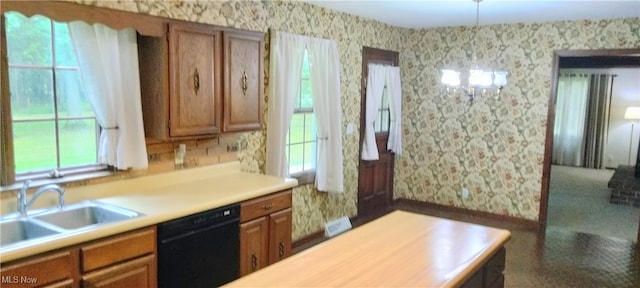 kitchen with a wealth of natural light, black dishwasher, and sink