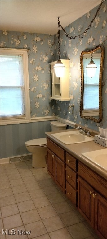 bathroom featuring tile patterned floors, vanity, and toilet