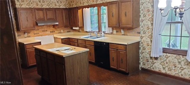 kitchen with black dishwasher, butcher block counters, sink, and a center island