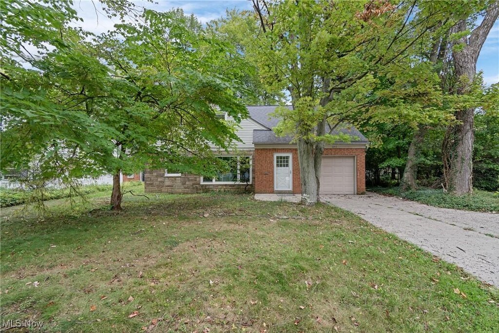 view of front of property with a garage and a front lawn