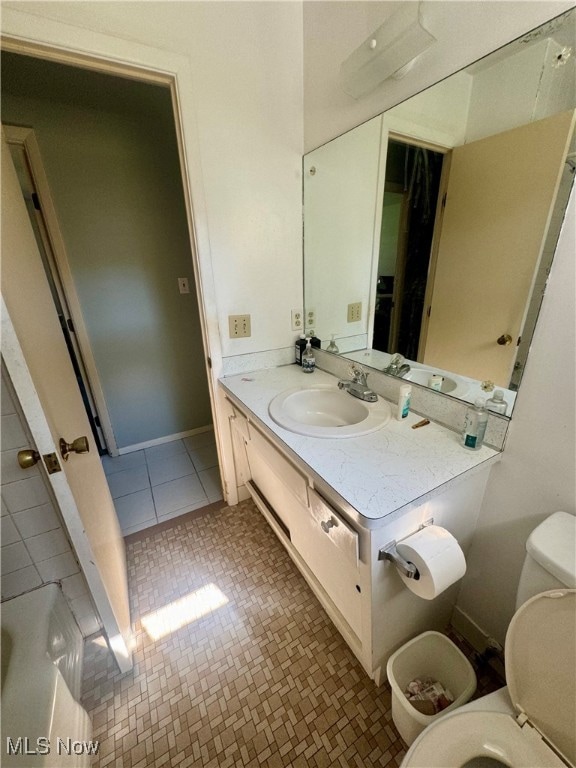 bathroom with tile patterned floors, toilet, and vanity