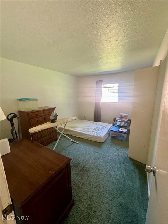 carpeted bedroom featuring a textured ceiling