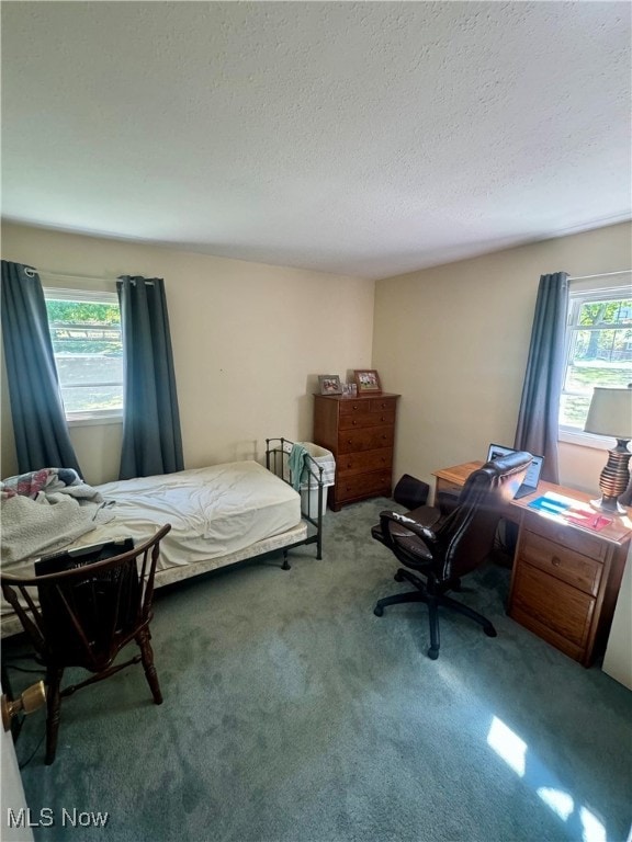 carpeted bedroom featuring a textured ceiling