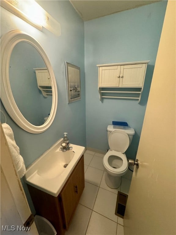 bathroom with tile patterned floors, toilet, and vanity