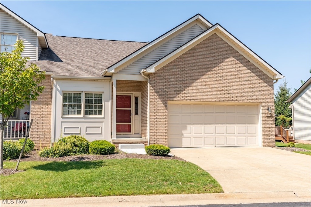 view of front of house with a front yard and a garage