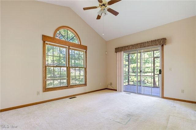 carpeted spare room with high vaulted ceiling and ceiling fan