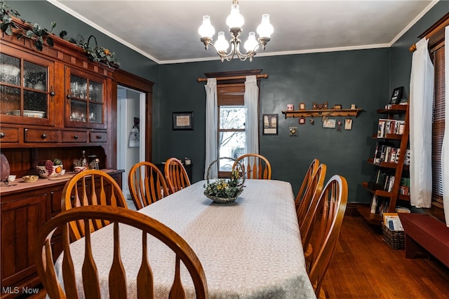 dining space featuring ornamental molding, dark wood-type flooring, and a notable chandelier