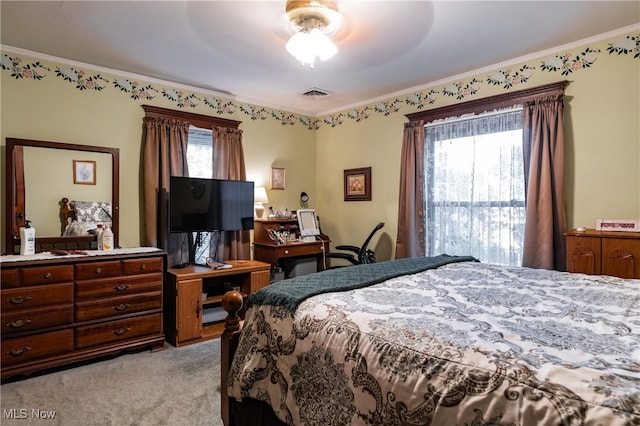 bedroom with ceiling fan, ornamental molding, light carpet, and multiple windows