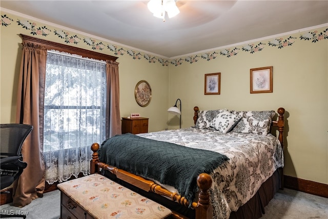 carpeted bedroom with ceiling fan and ornamental molding