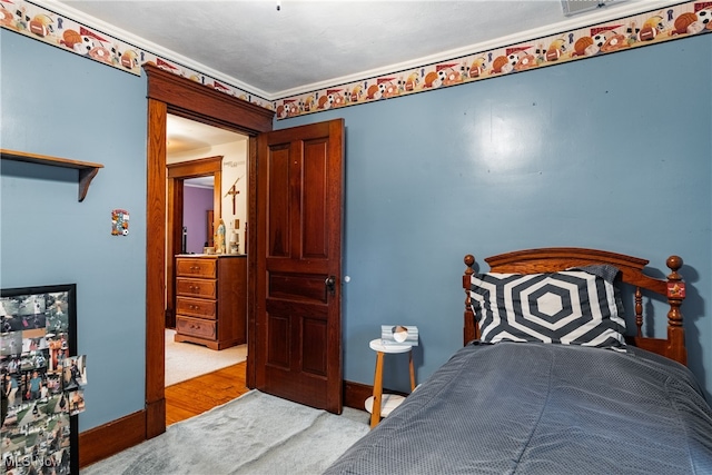 carpeted bedroom with crown molding