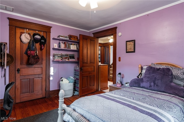 bedroom with ornamental molding and hardwood / wood-style flooring