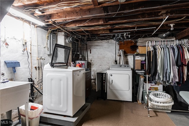 basement featuring separate washer and dryer, sink, and gas water heater