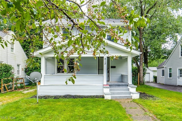 bungalow-style house featuring covered porch and a front lawn