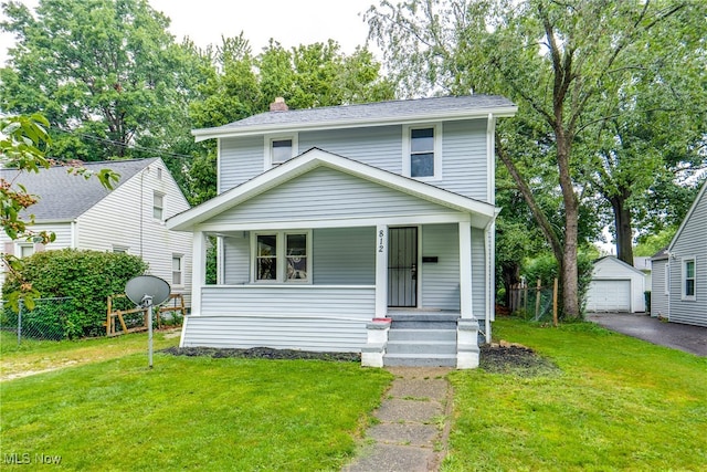 view of front of home featuring a front yard, an outdoor structure, a garage, and a porch