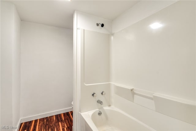 bathroom featuring toilet, shower / bathtub combination, and wood-type flooring