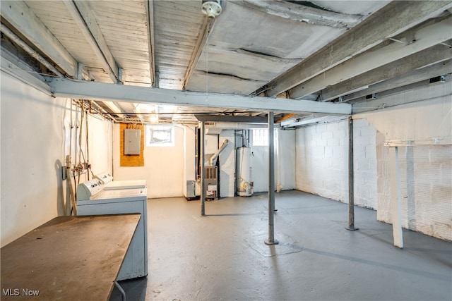 basement featuring gas water heater, a wealth of natural light, electric panel, and independent washer and dryer