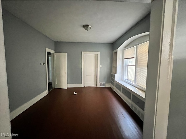 empty room featuring dark hardwood / wood-style flooring