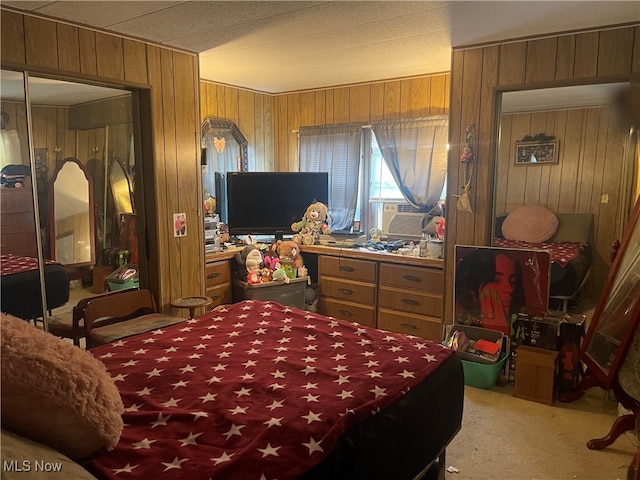 bedroom with wood walls and carpet